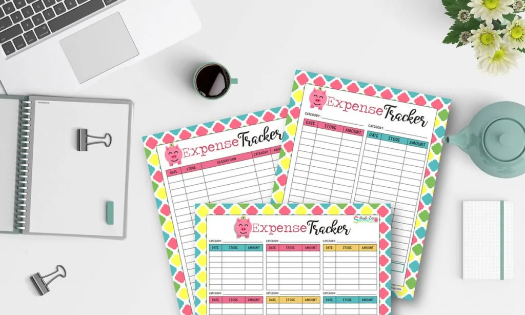 3 free printable expense tracker form and a laptop on the table