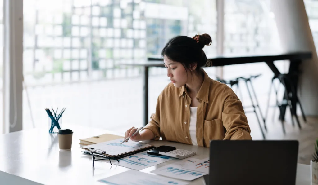 accountant business woman using calculator and computer laptop