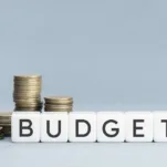 Budget word on blocks shape and coins stacked. Copy space