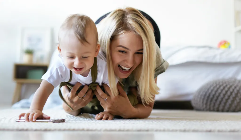 energetic mom playing active games with baby boy
