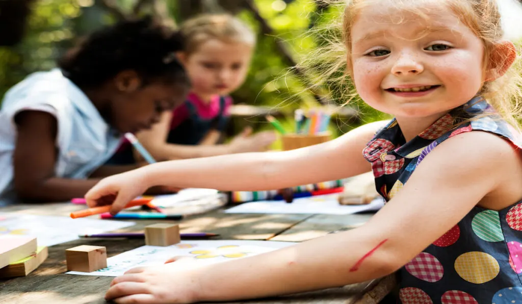 Group of children drawing outdoors