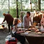 friends cooking and enjoying each others company at a picnic