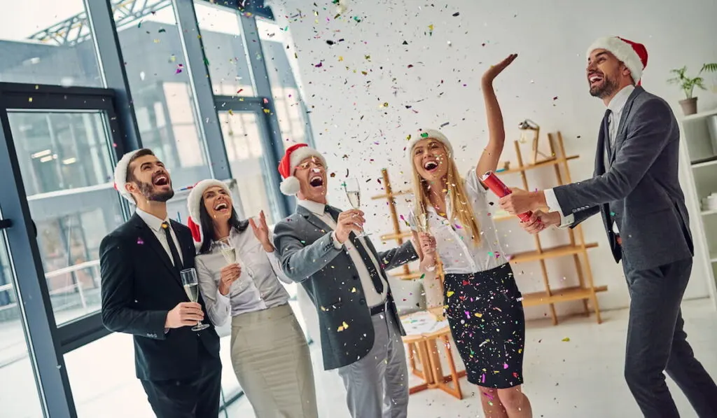 group of office workers celebrating winter holidays