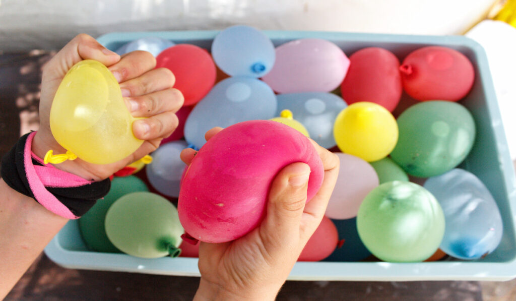 Hands holding water balloons