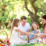 happy family on a picnic in the park on a sunny day