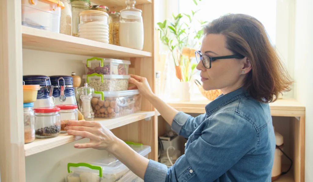 interior of wooden pantry with products for cooking.