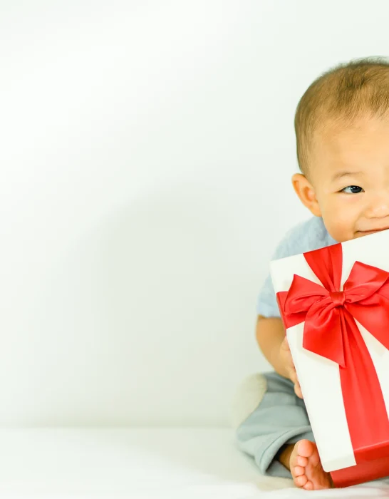 cute baby holding a gift
