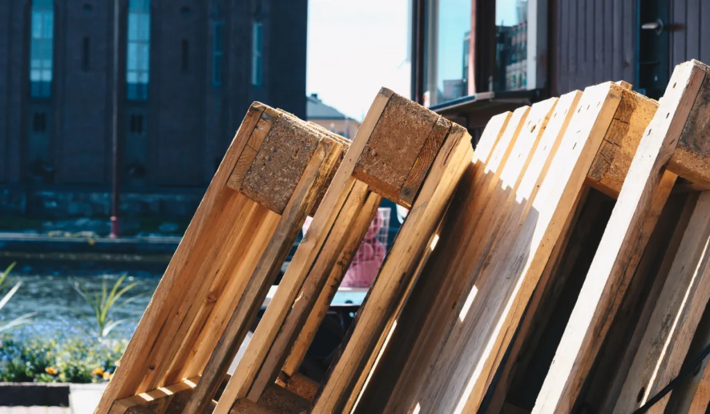 shipping pallets lying around in a construction site 
