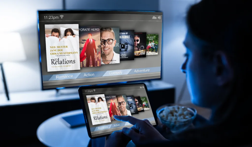 woman scanning movies on her ipad to watch
