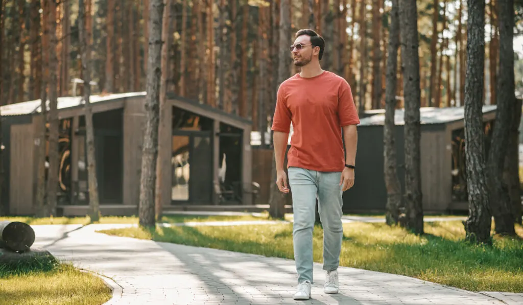 Young man walking in the park zone