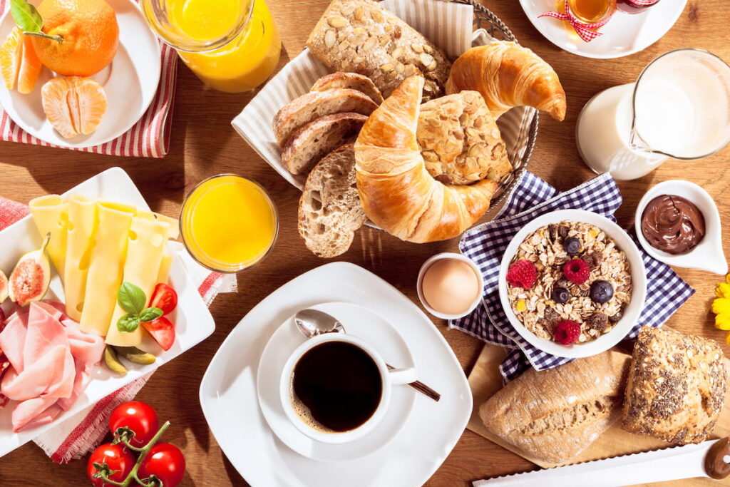 breakfast meals bread, coffee, oatmeal on table