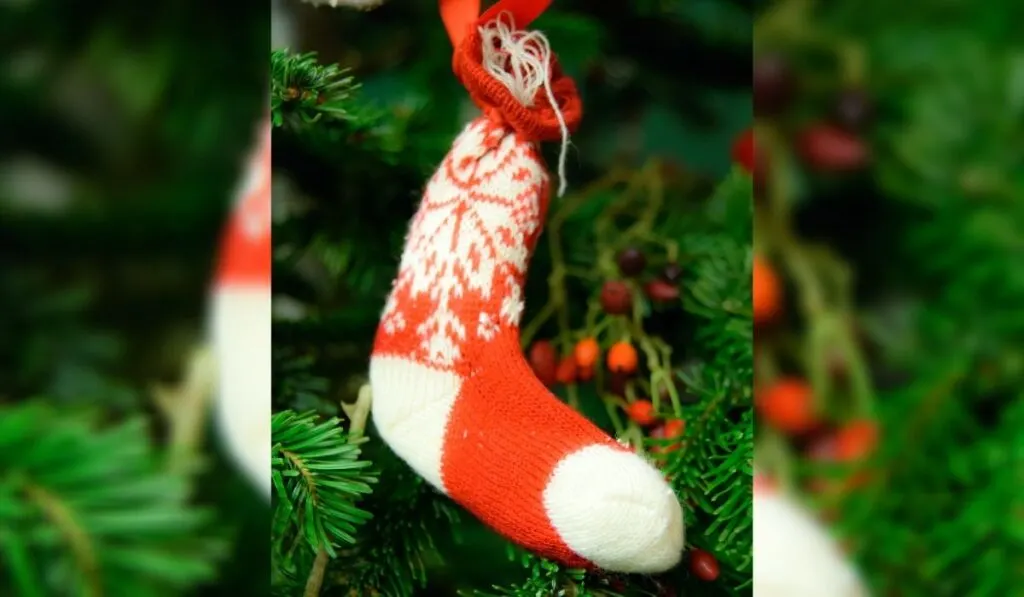 Red and White Christmas sock hanging on a Christmas Tree