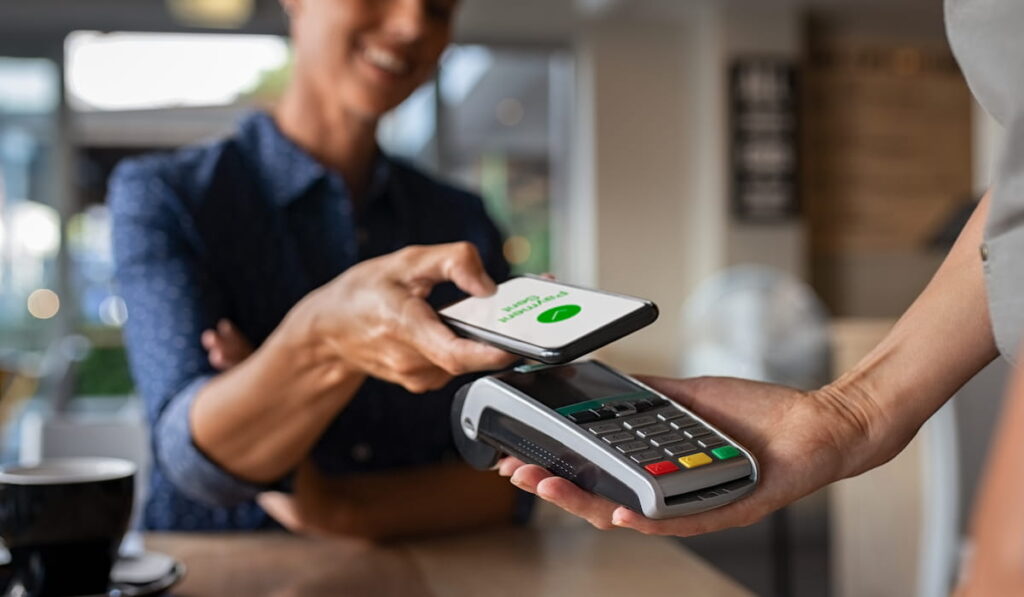 customer paying through mobile phone using contactless technology