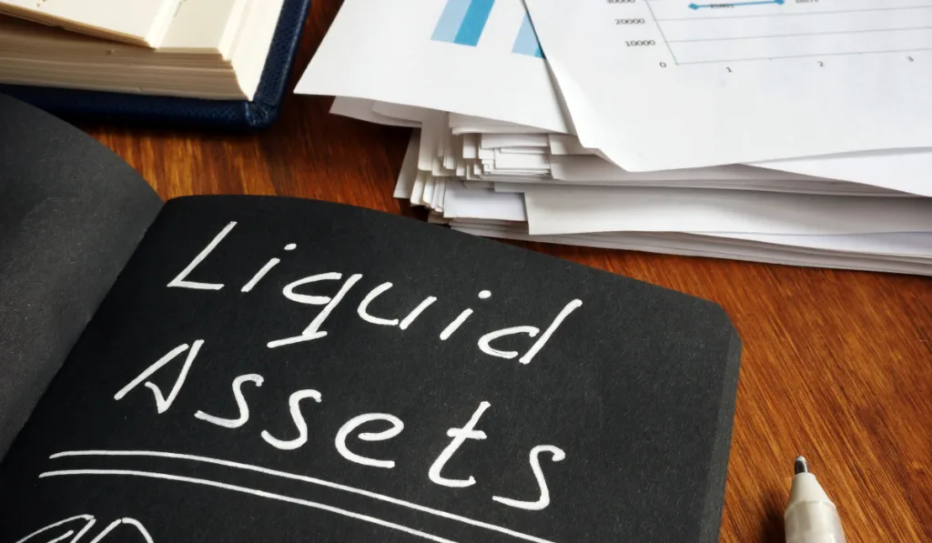 liquid assets notepad list and calculations on the table
