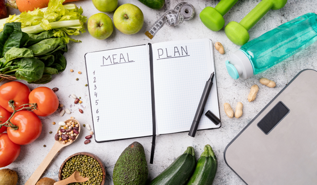meal plan notepad and some fruits and vegetables on the table