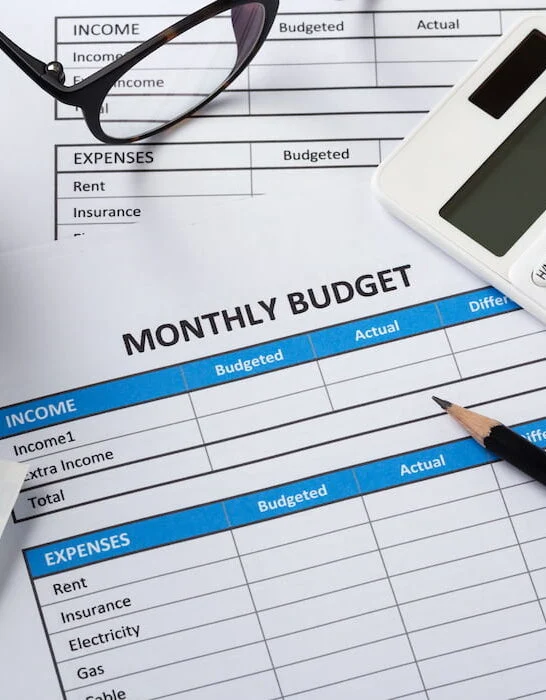 monthly budget sheet on the table with pencil and calculator