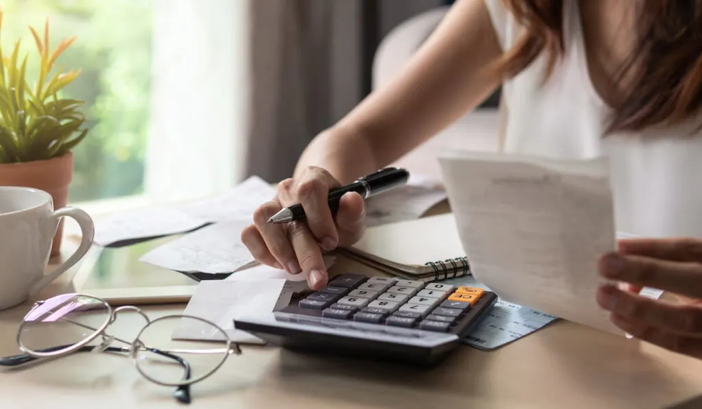 woman calculating monthly home expenses