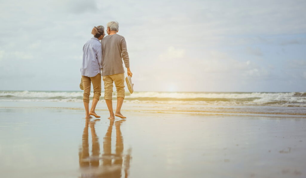 couple retirees standing on beach
