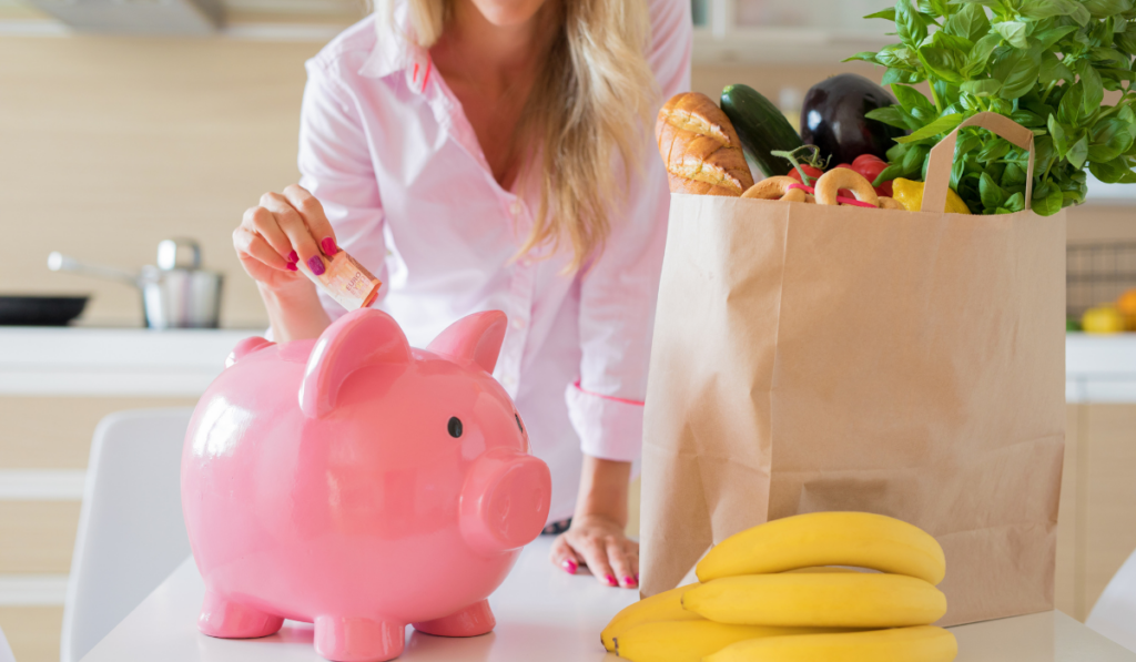 woman adding bills in her big piggy bank, savings on her grocery
