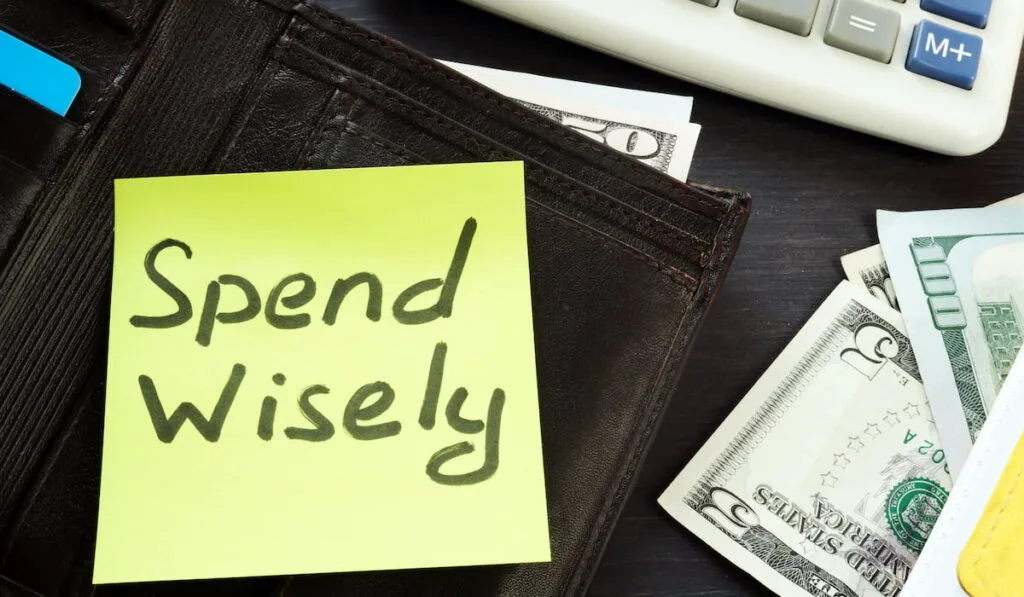 spend wisely note on top of a wallet