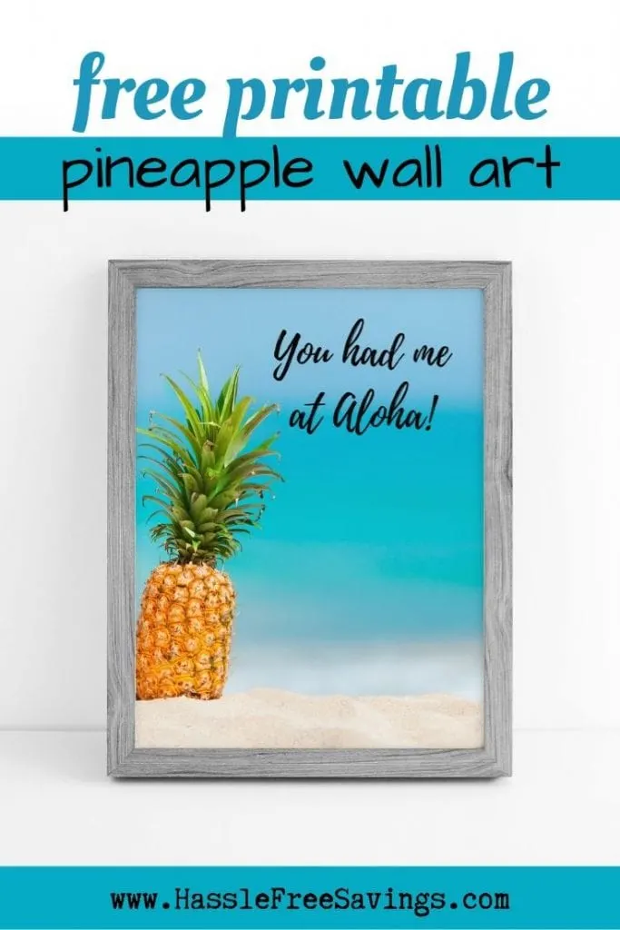 Free Printable "You Had me at Aloha" Pineapple Quote Fresh Looking Pineapple sitting on the beach sand with a beautiful ocean in the back.